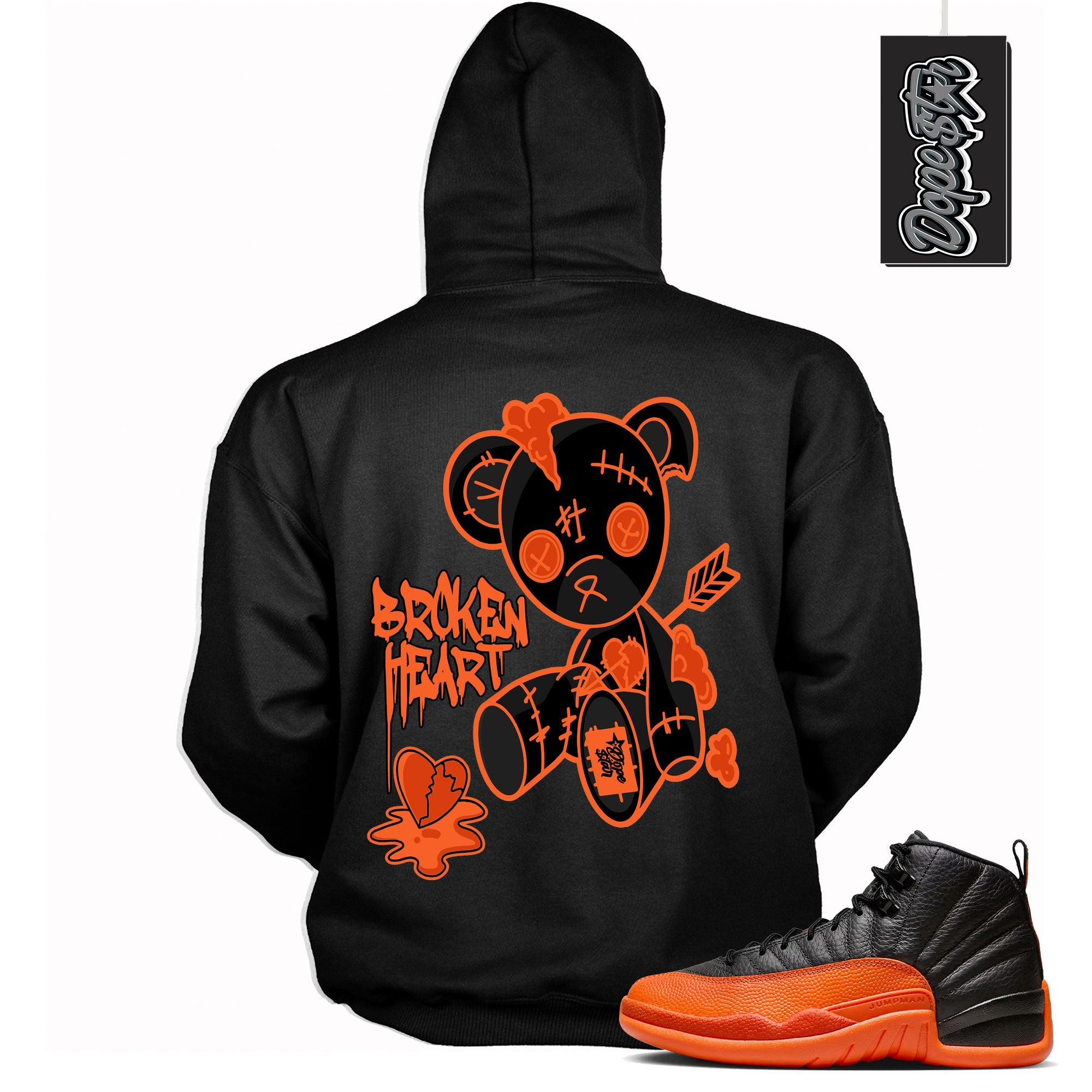 Cool Black Graphic Hoodie with “ Broken Heart Bear “ print, that perfectly matches Air Jordan 12 Retro WNBA All-Star Brilliant Orange sneakers
