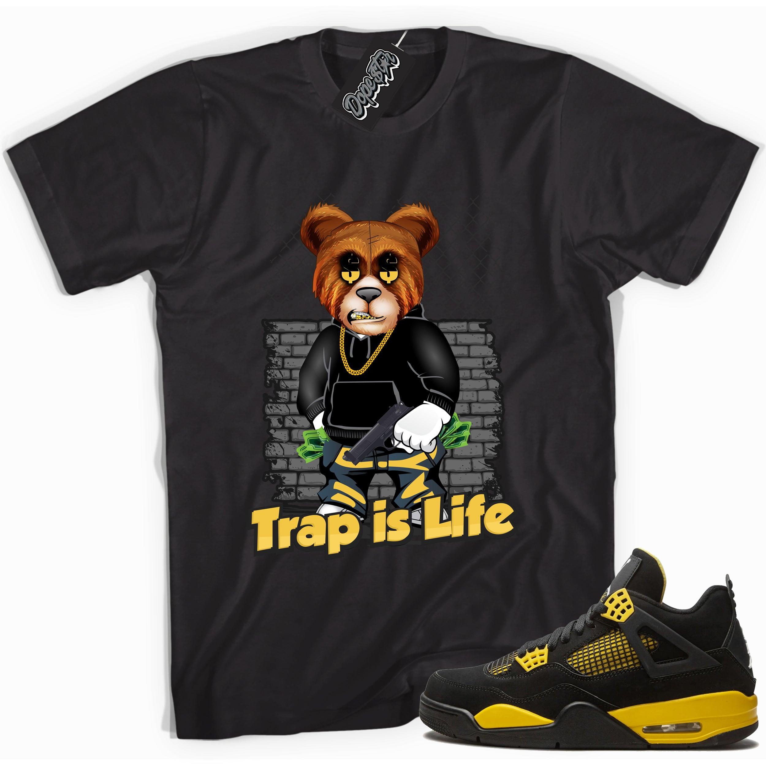 Cool black graphic tee with 'trap is life' print, that perfectly matches Air Jordan 4 Thunder sneakers
