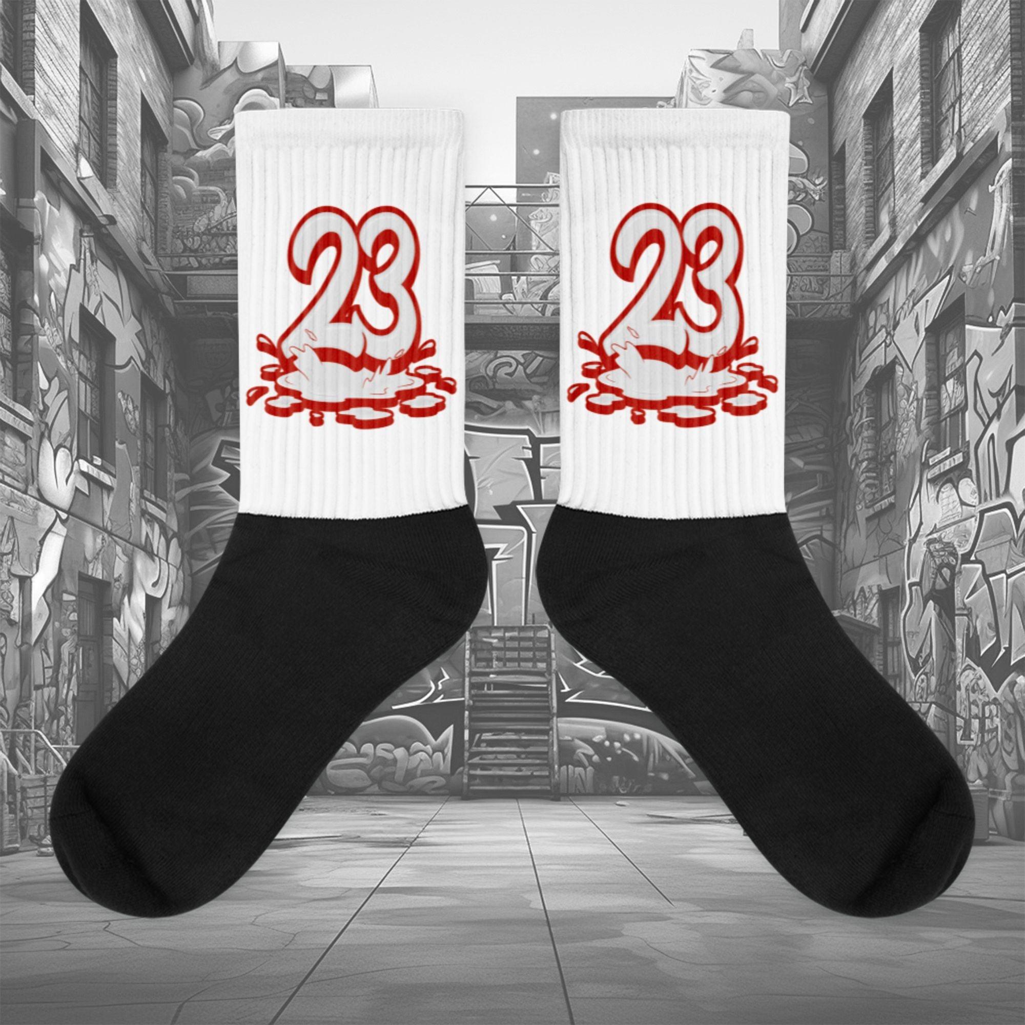 Showcases the view of the socks, highlighting the vibrant ' 23 Melting ' design, which perfectly complements the Air Jordan 11 Cherry sneakers. The intricate pattern and color scheme inspired by the theme are prominently displayed. Focusing on the ribbed leg , cusioned bottoms and the snug fit of the socks. This angle provides a clear view of the texture and quality of the material blend.
