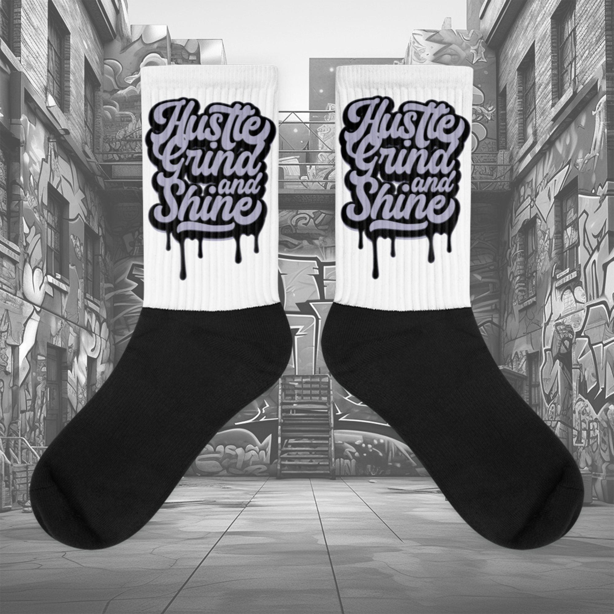 Showcases the view of the socks, highlighting the vibrant ‘Hustle Grind And Shine’ design, which perfectly complements the Air Jordan 8 Winterized sneakers. The intricate pattern and color scheme inspired by the theme are prominently displayed. Focusing on the ribbed leg , cusioned bottoms and the snug fit of the socks. This angle provides a clear view of the texture and quality of the material blend.