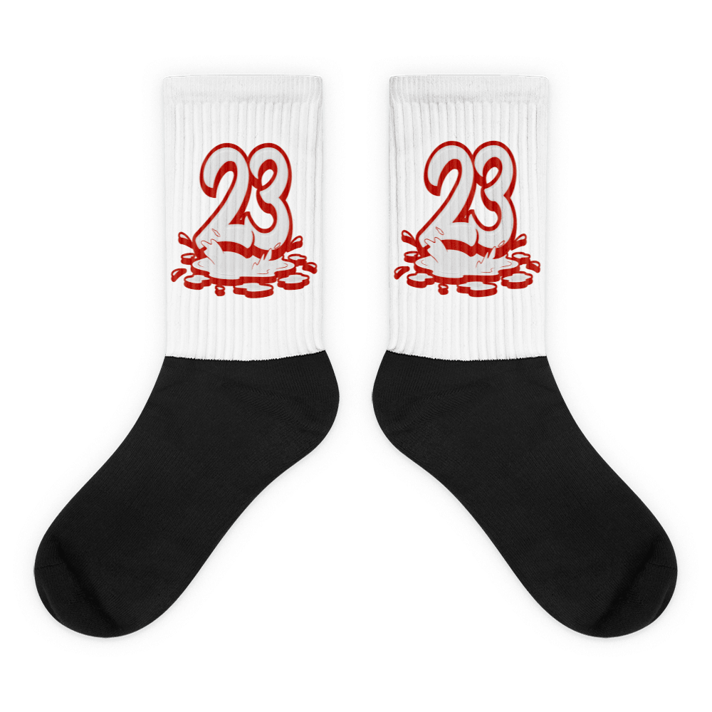 Showcases the view of the socks, highlighting the vibrant ' 23 Melting ' design, which perfectly complements the Air Jordan 11 Cherry sneakers. The intricate pattern and color scheme inspired by the theme are prominently displayed. Focusing on the ribbed leg , cusioned bottoms and the snug fit of the socks. This angle provides a clear view of the texture and quality of the material blend.
