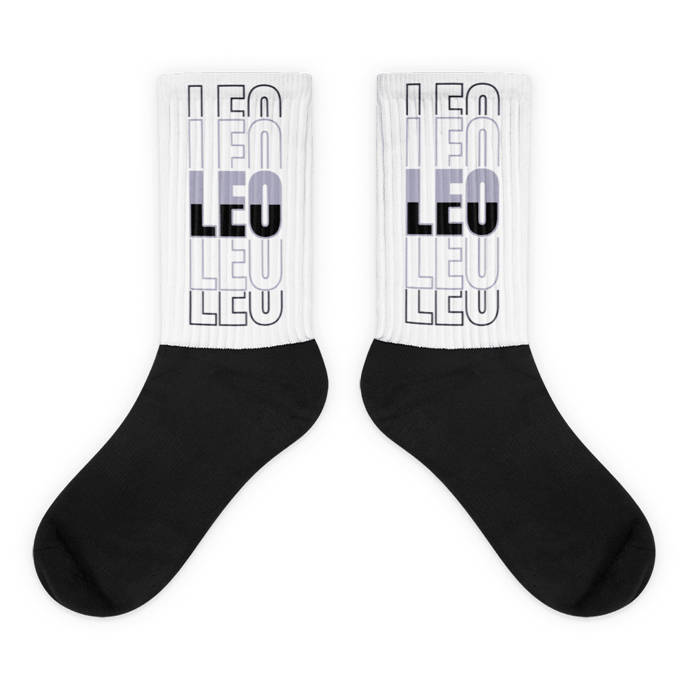 Showcases the view of the socks, highlighting the vibrant 'LEO' design, which perfectly complements the Air Jordan 8 Winterized sneakers. The intricate pattern and color scheme inspired by the theme are prominently displayed. Focusing on the ribbed leg , cusioned bottoms and the snug fit of the socks. This angle provides a clear view of the texture and quality of the material blend.