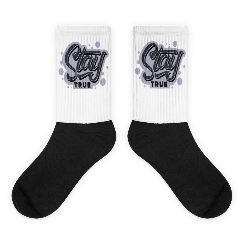 Showcases the view of the socks, highlighting the vibrant 'Stay True' design, which perfectly complements the Air Jordan 8 Winterized sneakers. The intricate pattern and color scheme inspired by the theme are prominently displayed. Focusing on the ribbed leg , cusioned bottoms and the snug fit of the socks. This angle provides a clear view of the texture and quality of the material blend.