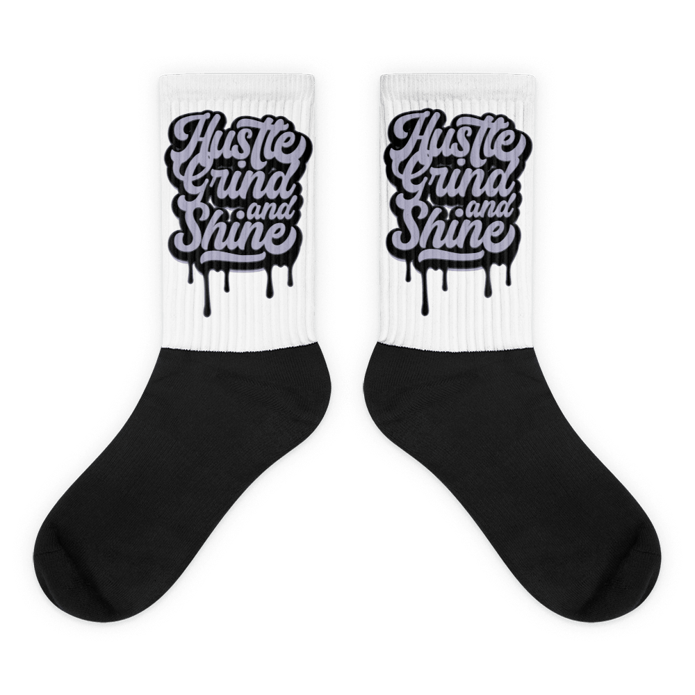 Showcases the view of the socks, highlighting the vibrant ‘Hustle Grind And Shine’ design, which perfectly complements the Air Jordan 8 Winterized sneakers. The intricate pattern and color scheme inspired by the theme are prominently displayed. Focusing on the ribbed leg , cusioned bottoms and the snug fit of the socks. This angle provides a clear view of the texture and quality of the material blend.